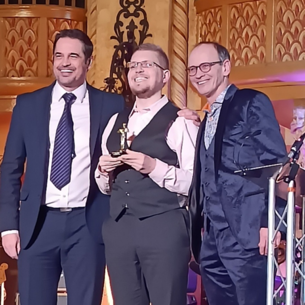 Simon Cocker presenting an award to Smiley Scott alongside Steve Royle